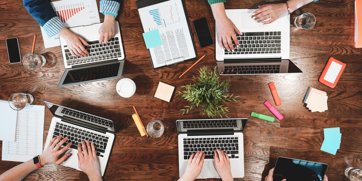 Top,View,Of,Coworking,People,Sitting,Together,Around,Table.,Business