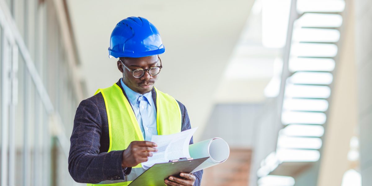 Foreman,At,Work,On,Construction,Site,Checking,His,Notes,And