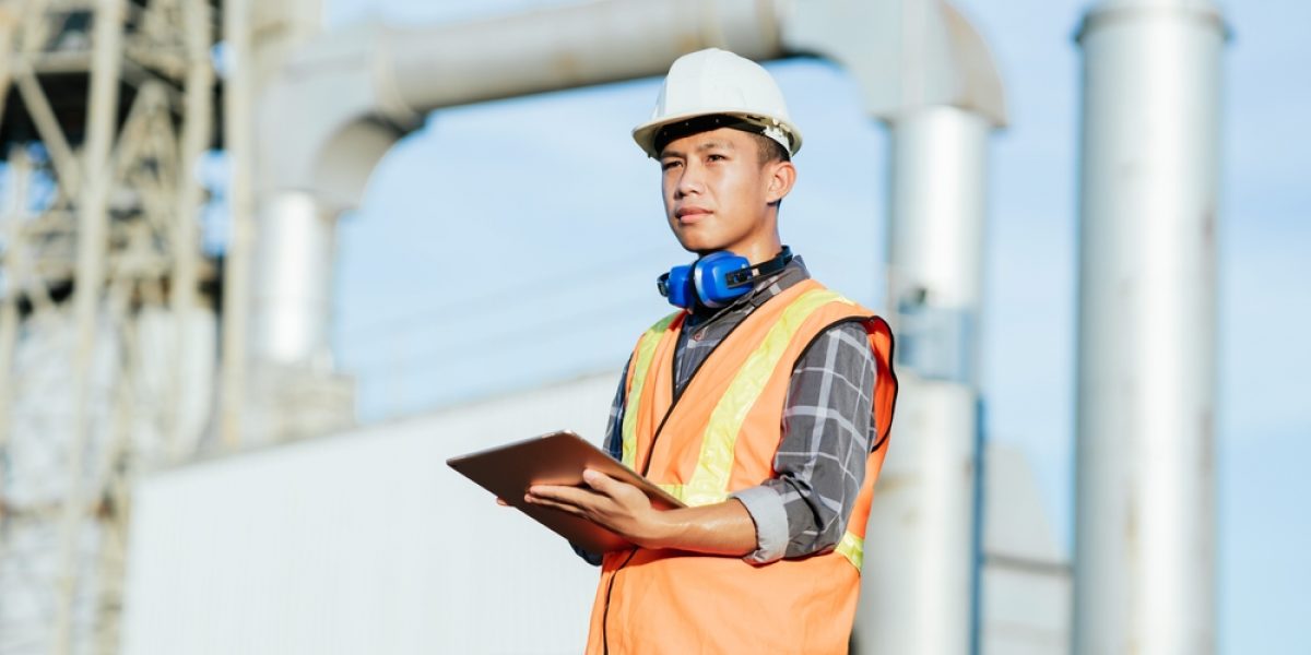 Construction,Engineer,Standing,At,Construction,Building,Site,With,Ipad,For